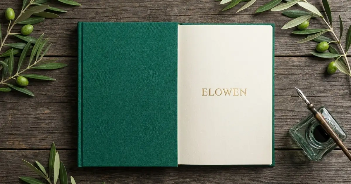 The name Elowen embossed in gold lettering on a linen journal surrounded by olive branches