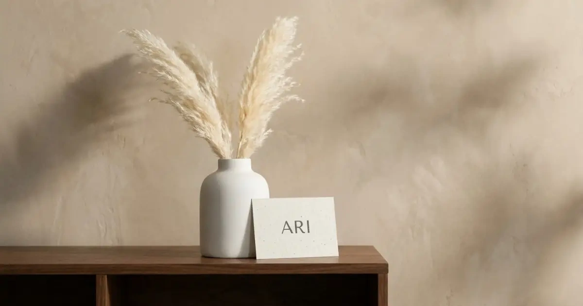 A modern, minimalist setting featuring a gender-neutral international baby name written on a card.